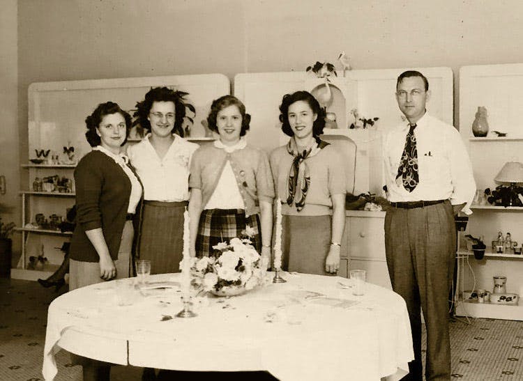 Busch's owner and four coworkers, gathered around a dining room centerpiece some time in the 1950s